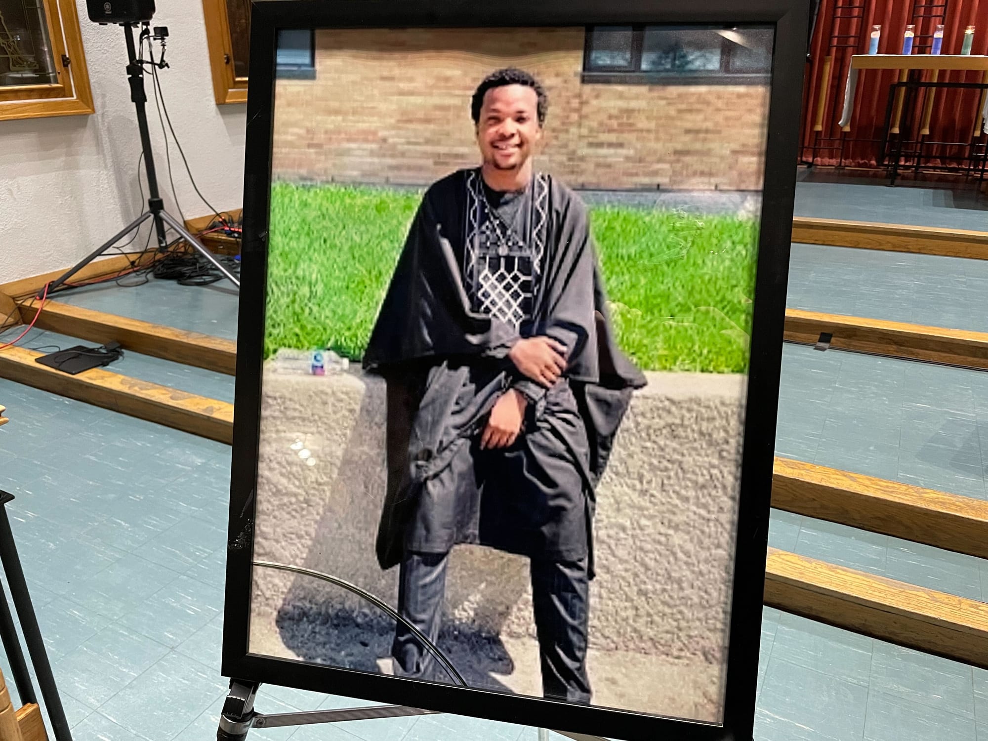 Photo of framed picture of Afolabi Opaso taken at vigil.