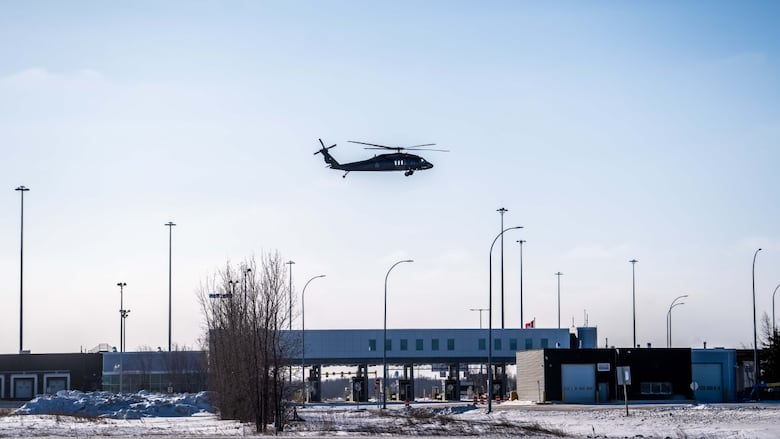 Photo of Black Hawk helicopter flying above Manitoba-US border